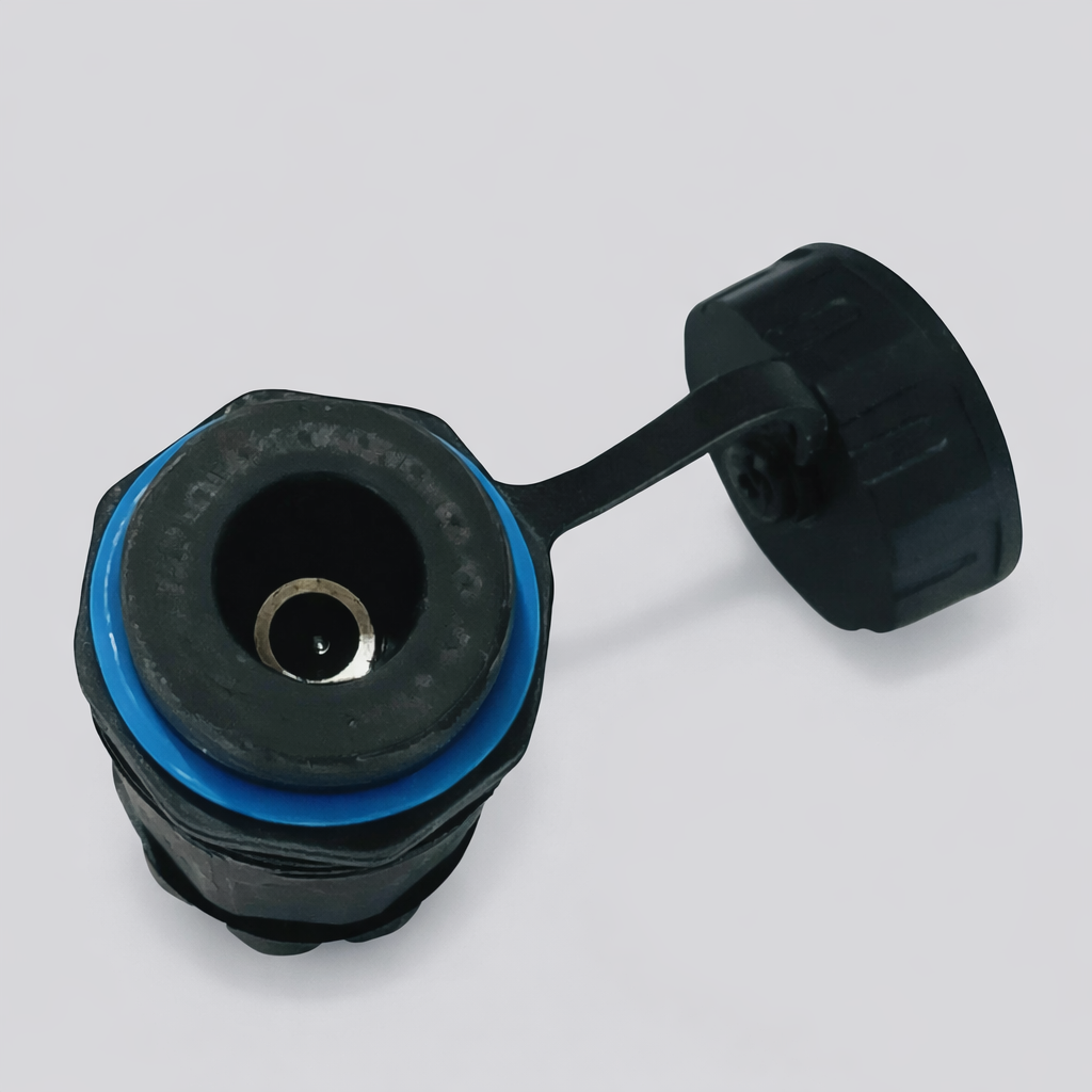Top-down view of Starlink Mini DC panel connector socket with cap open, showing sealing detail and waterproof housing