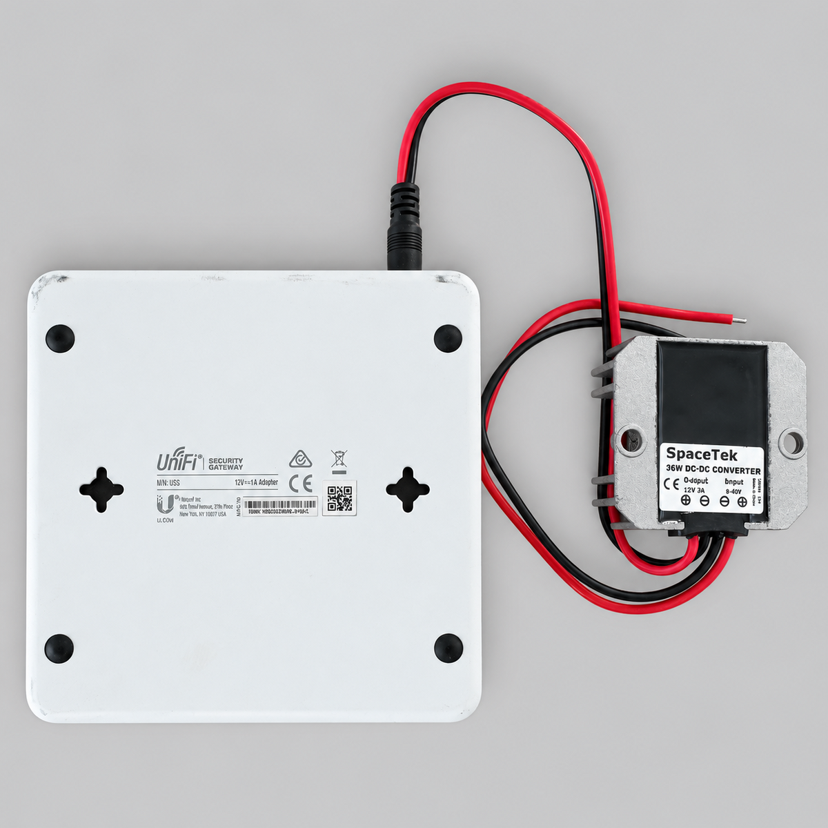 pacetek 36W DC-DC converter connected to the rear power input of a Ubiquiti UniFi USG security gateway