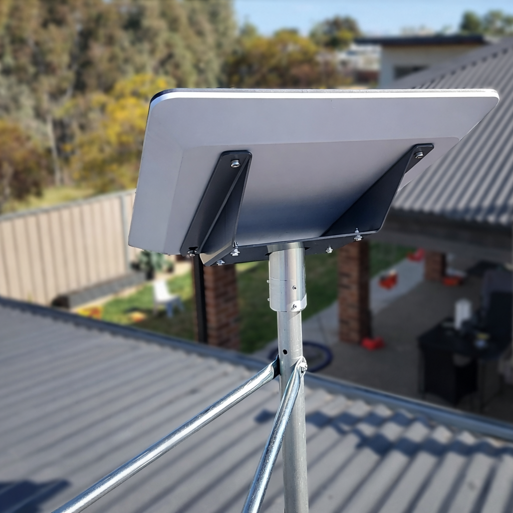 Close-up side view of Spacetek pole adaptor kit supporting a Starlink Performance dish on a metal rooftop
