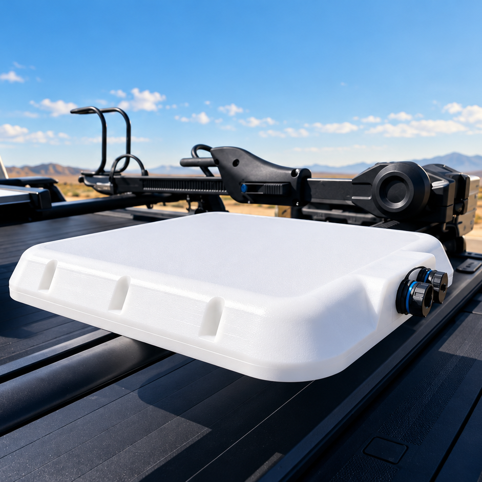 Spacetek Starlink V-Cell IP68 rugged protective housing mounted on a ute tray, with a low-profile design and weatherproof cable connectors in a remote landscape.