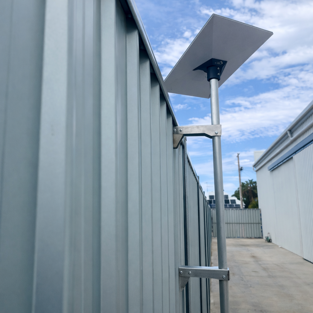 Side view of a Starlink Gen 3 dish mounted to a metal fence using a heavy duty aluminium Atco fence mount bracket.