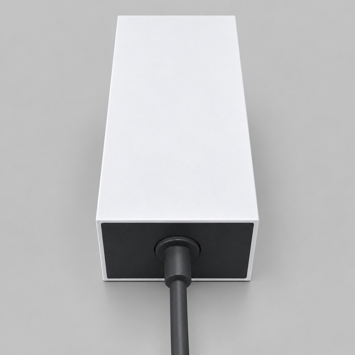Starlink Mini AC/DC power supply with white housing and integrated black power cable, showing the cable connection and strain relief