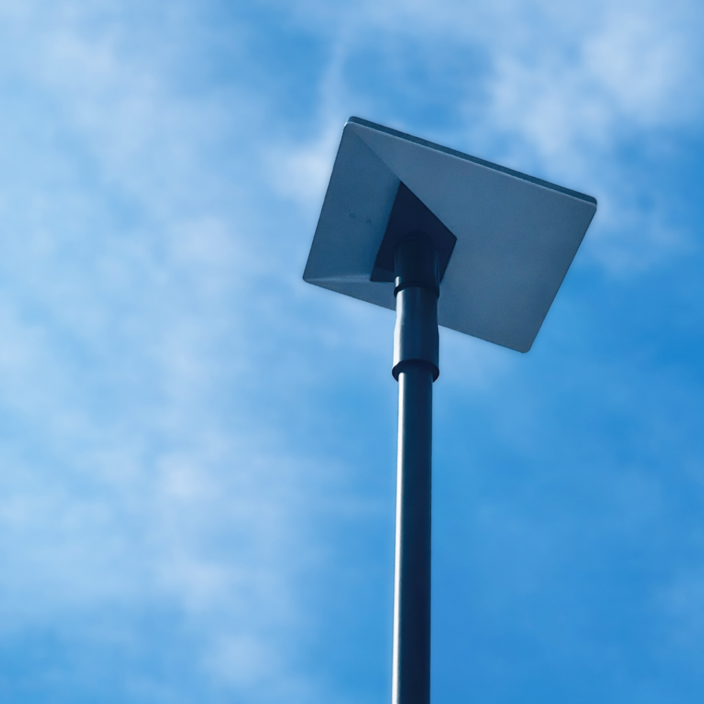 Low angle view of Starlink mini receiver mounted on Spacetek carbon fibre telescopic pole against blue sky with clouds