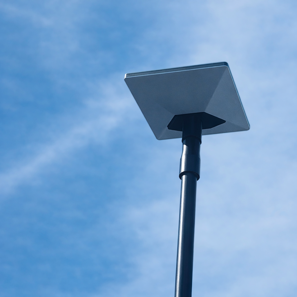 Low angle view of Starlink mini receiver mounted on Spacetek carbon fibre telescopic pole against blue sky with clouds