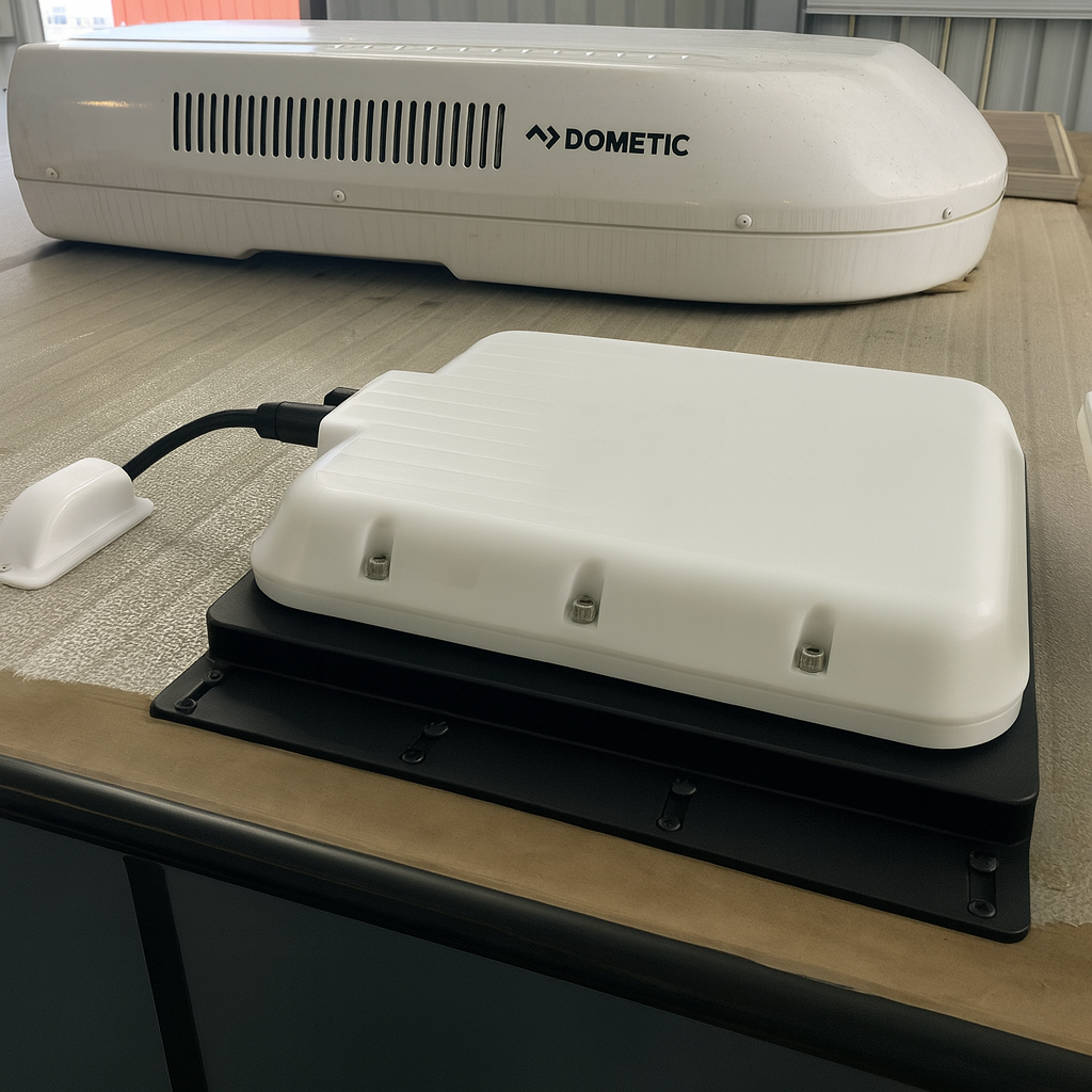 V-Cell rugged enclosure for Starlink Mini, roof-mounted next to Dometic air conditioner on fixed vehicle install