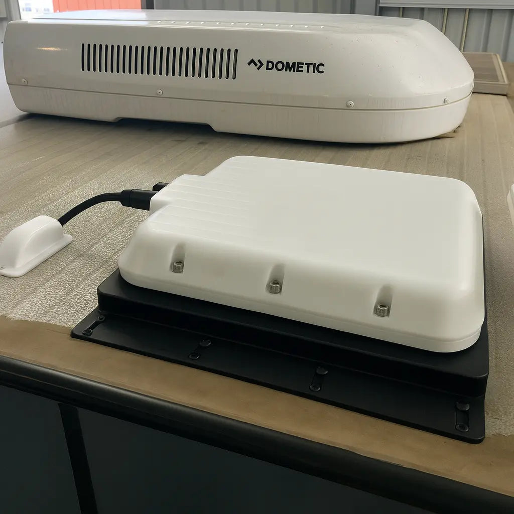 V-Cell rugged enclosure for Starlink Mini, roof-mounted next to Dometic air conditioner on fixed vehicle install