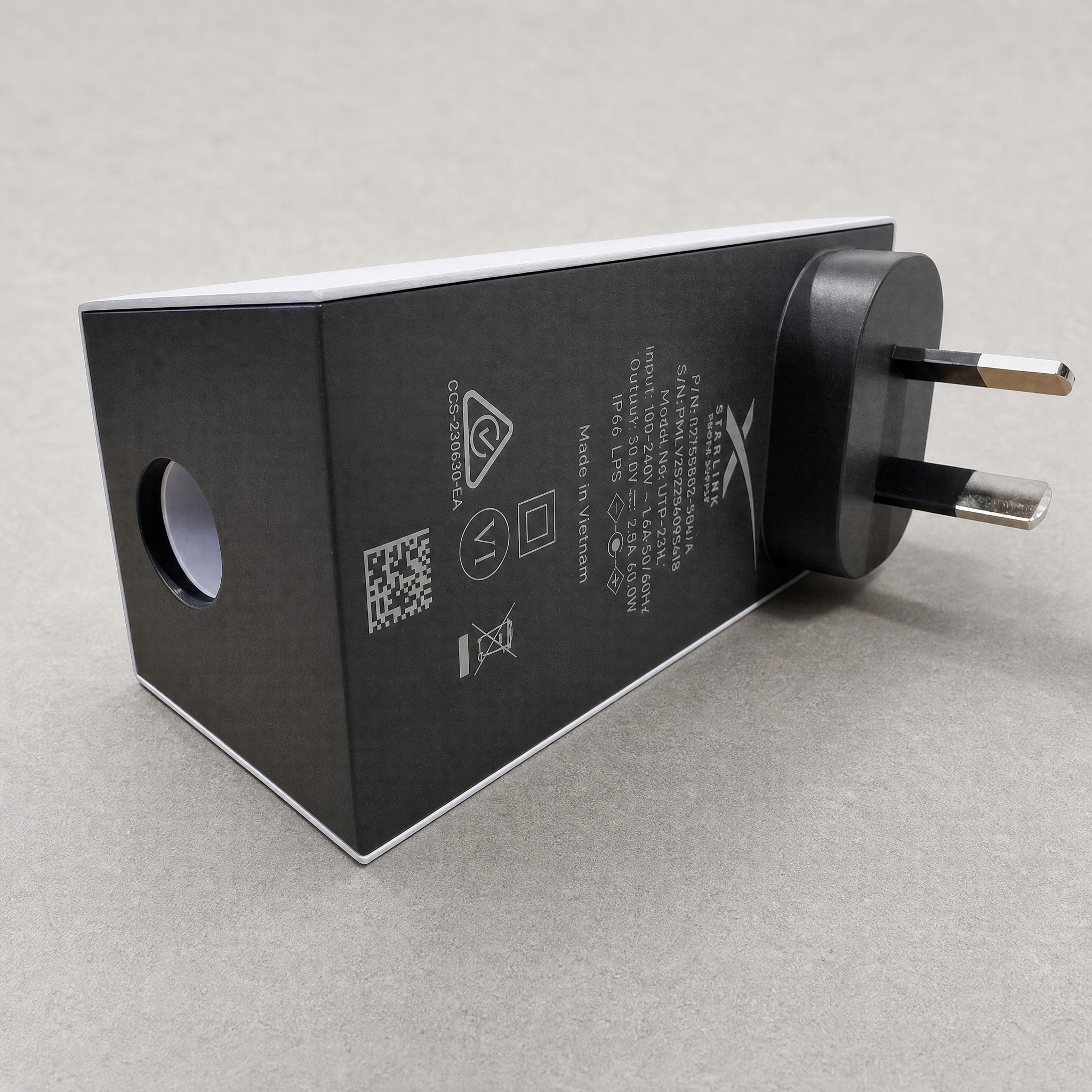Genuine replacement Starlink Mini AC power supply AU/NZ plug showing adapter label and prongs