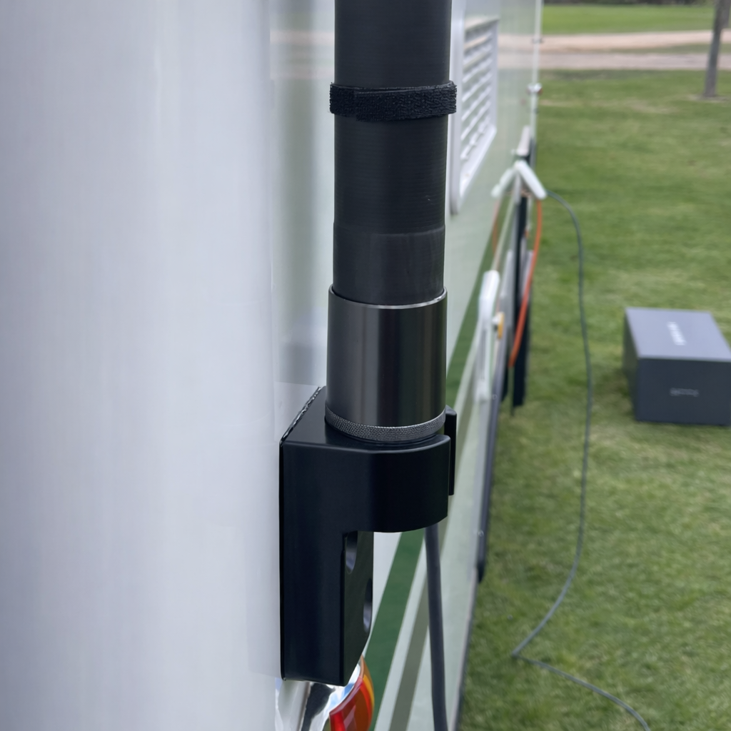 Close-up of Spacetek carbon fibre telescopic pole secured to caravan side wall using heavy-duty mounting bracket base for Starlink receiver