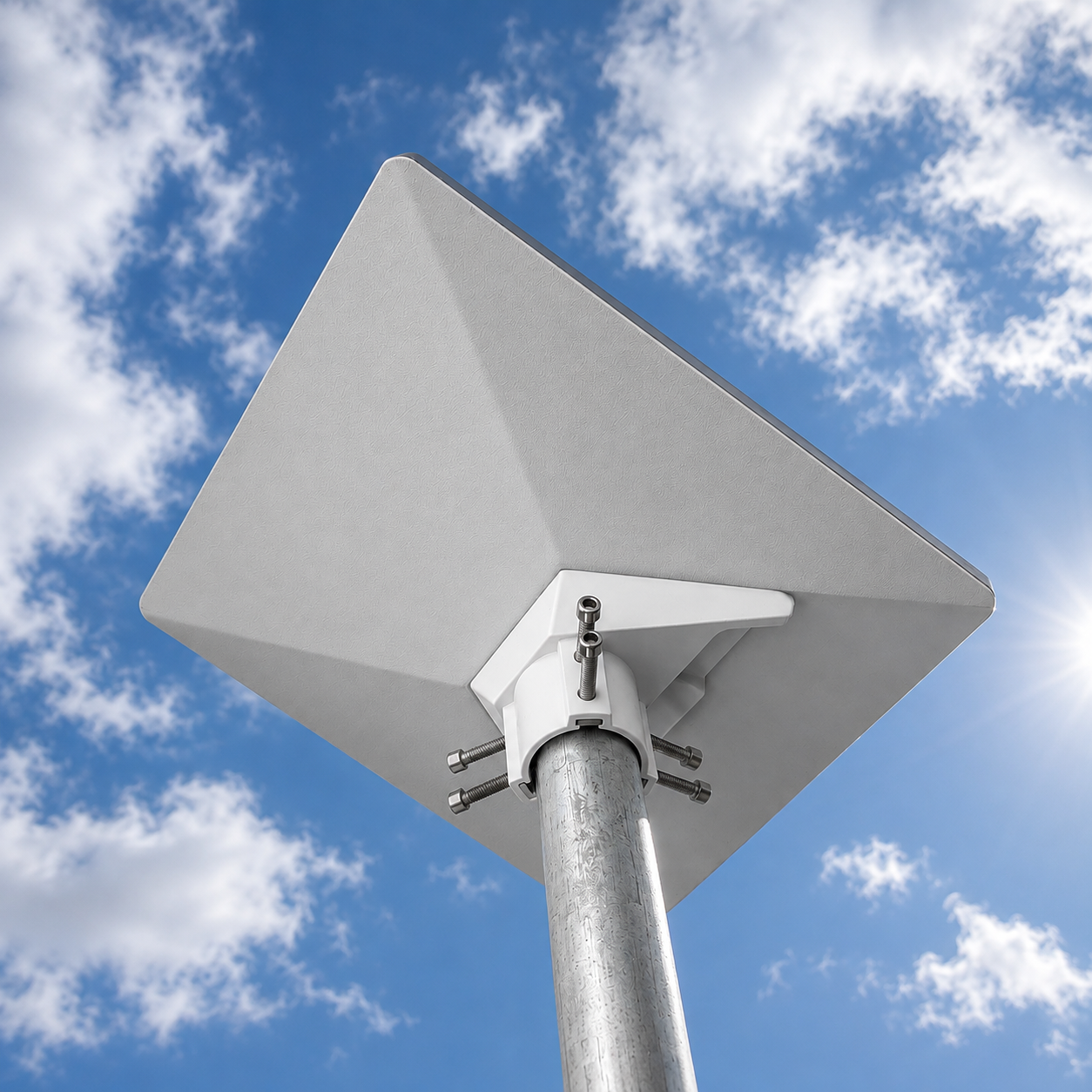 Low-angle view of the Spacetek Starlink Mini pole adaptor with six tension points securely mounting a Starlink Mini to a galvanized pole against a blue sky
