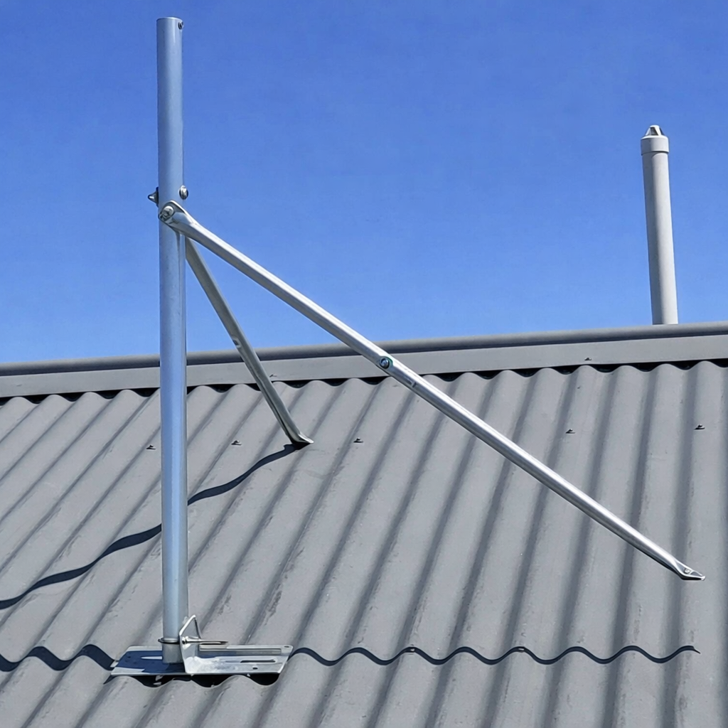 Complete Starlink Gen 2 tin roof mount kit installed with vertical mast and angled support arms fixed to corrugated metal roof under clear blue sky
