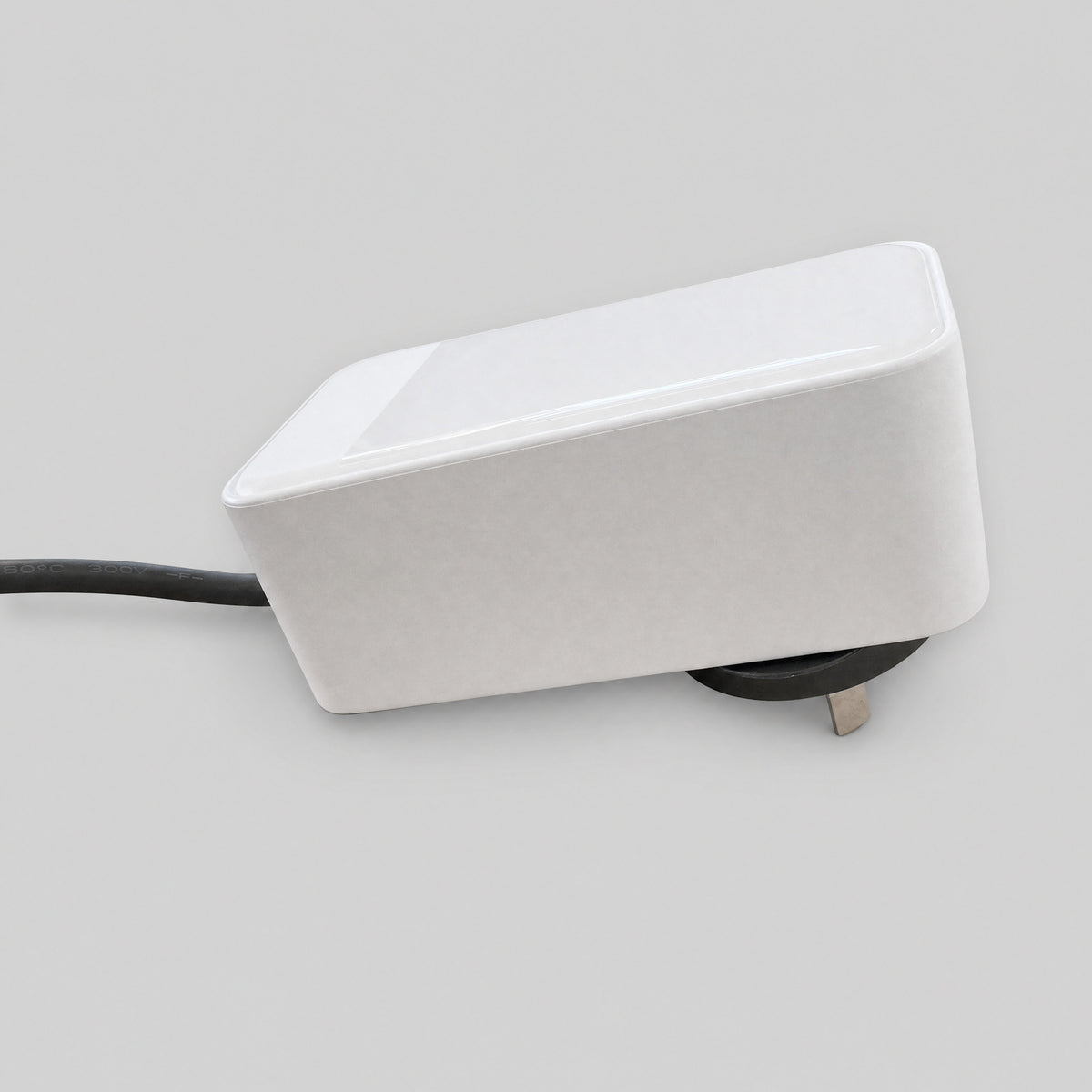 Side profile of the white Starlink Mini replacement AC power supply showing the slim wedge body and cable exit