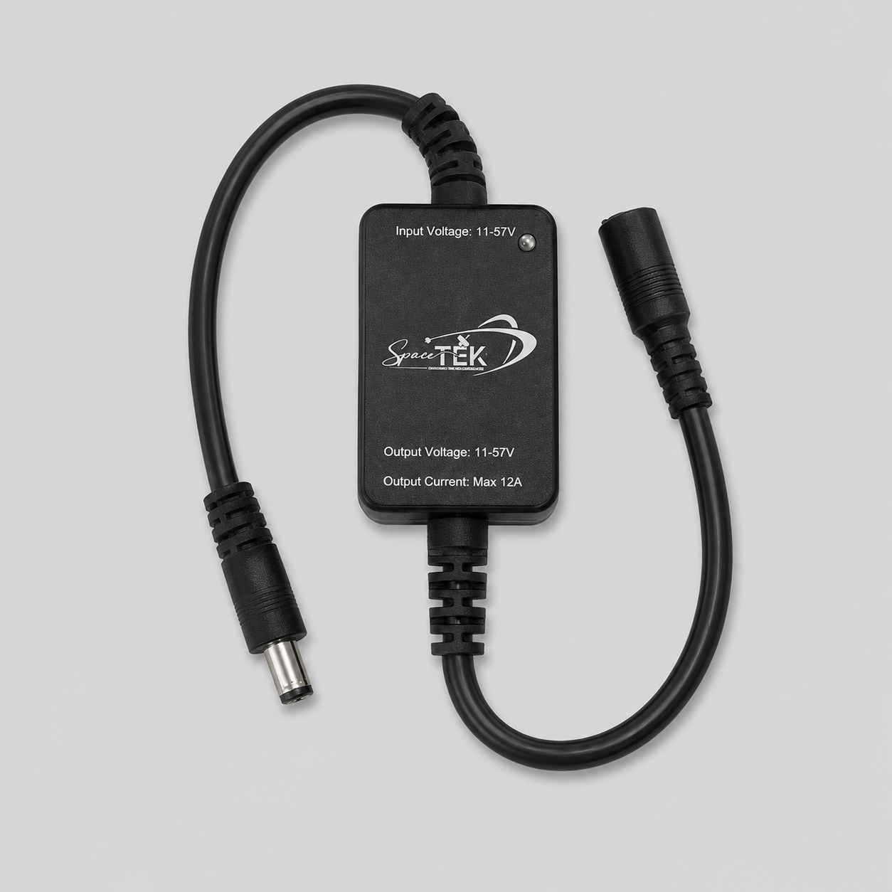 Close-up of Starlink Mini in-line wireless relay module with inline DC connectors and SpaceTEK branding
