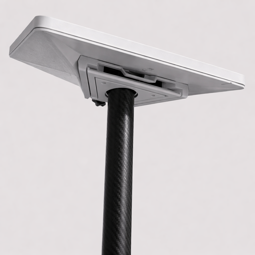 Starlink Mini combined kickstand and pipe adapter mounted on a carbon fiber pole, angled underside view showing mounting interface