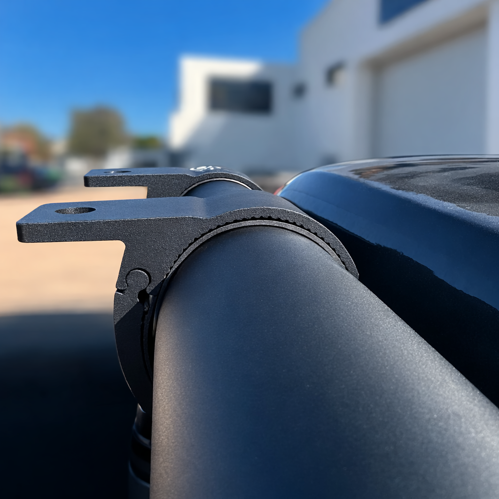 Starlink Mini compatible tube mount installed on a vehicle roof rack crossbar showing mounting tab for accessories.
