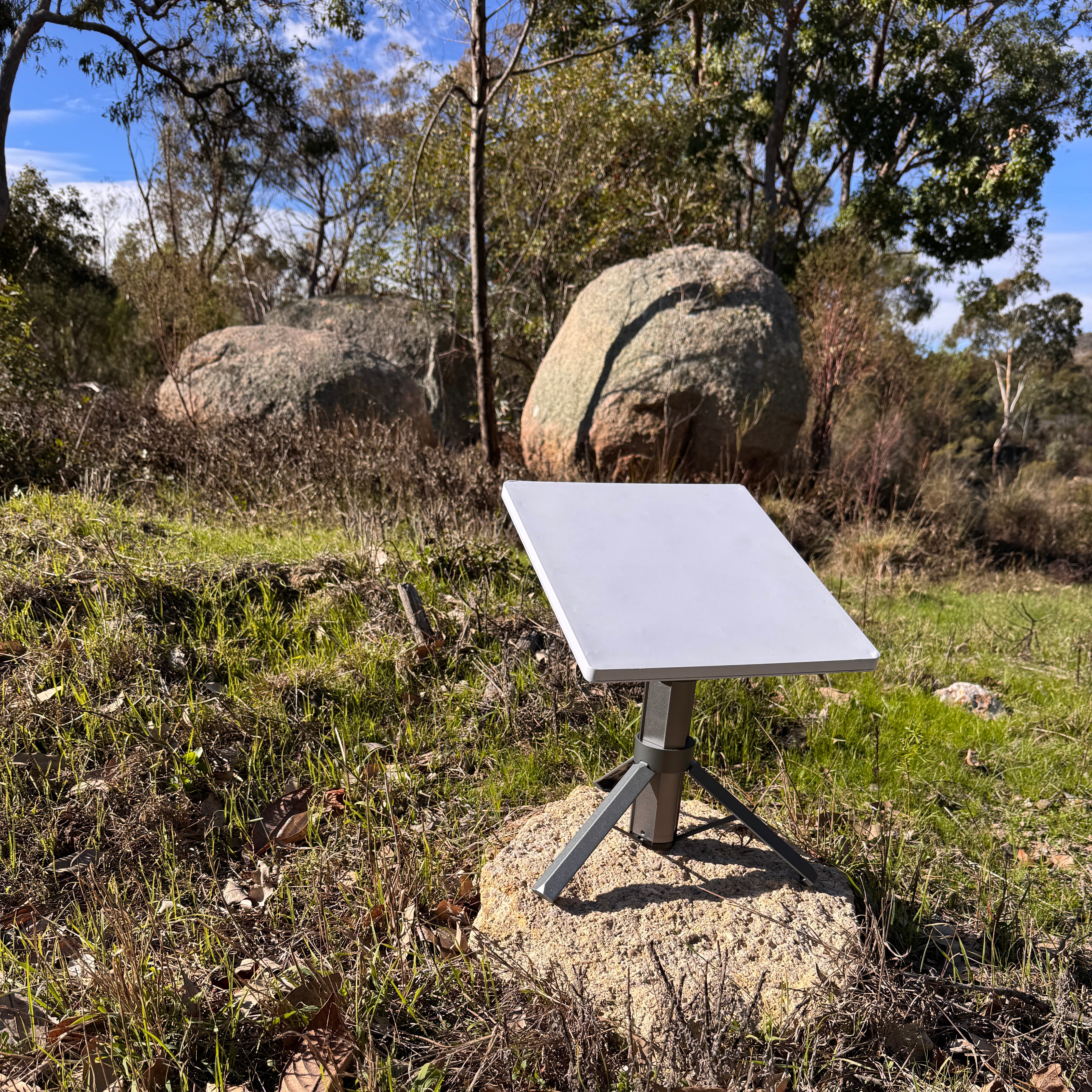 Starlink Mini mounted on the Spacetek Tripod Battery 9Ah in open bushland, demonstrating a stable portable satellite internet setup outdoors